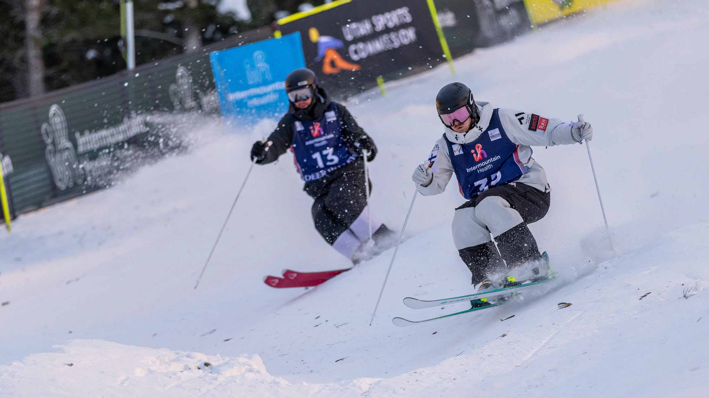 Two athletes competing in Intermountain Health Freestyle Ski World Cup dual moguls competition.